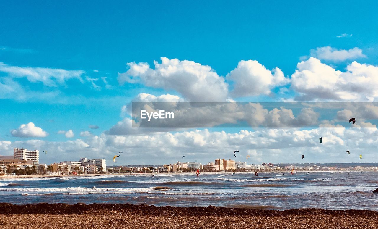 Windsurf on beach against sky