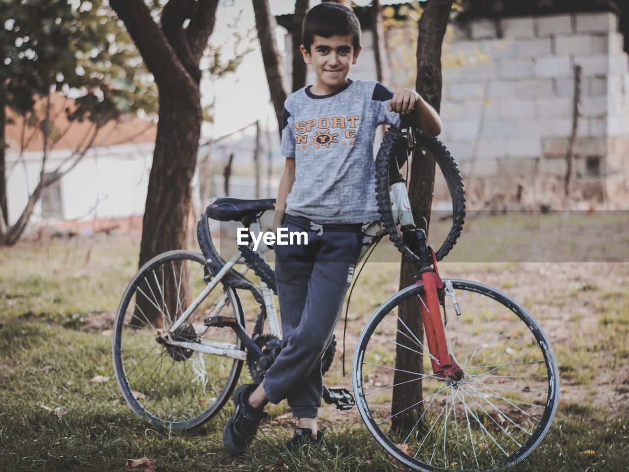 Portrait of boy with bicycle