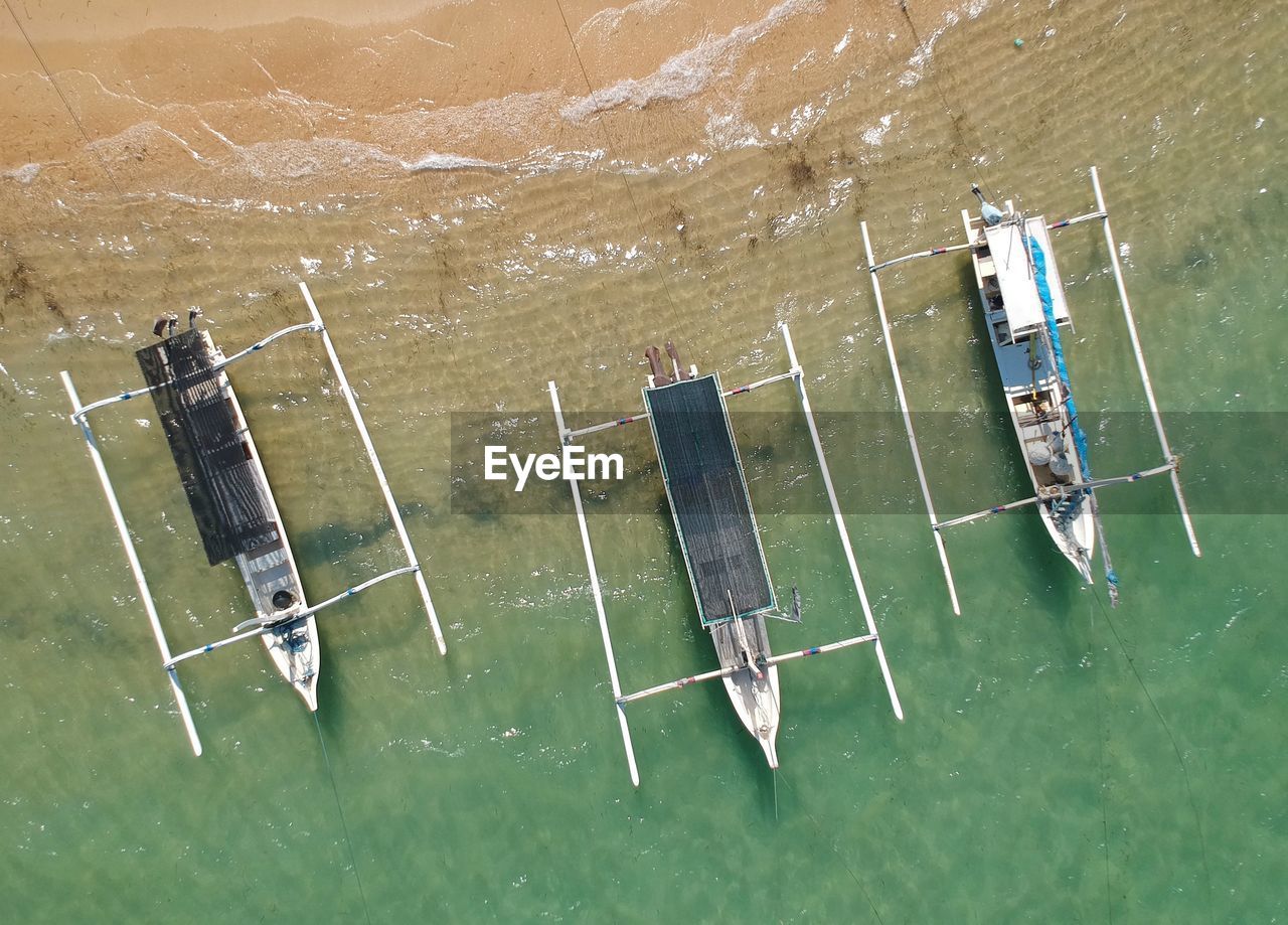 High angle view of outriggers in sea