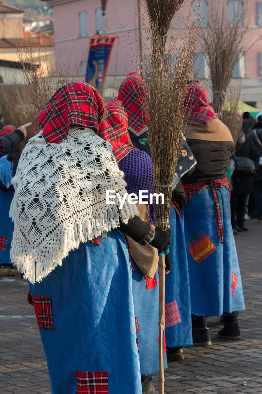 REAR VIEW OF WOMEN WALKING ON STREET