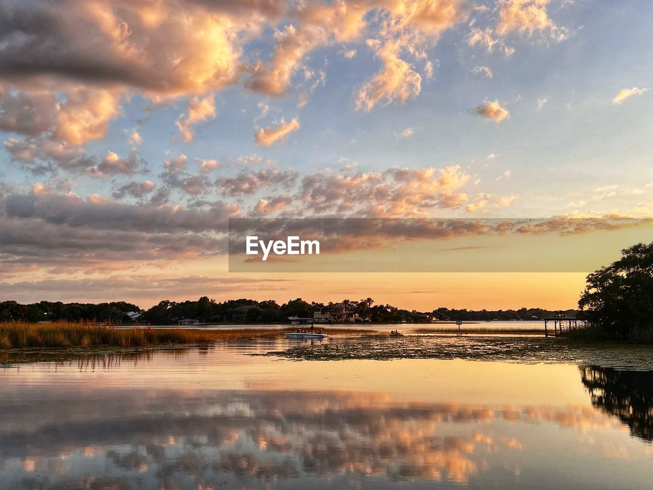 sky, water, cloud, reflection, sunset, beauty in nature, scenics - nature, nature, environment, tranquility, landscape, lake, tranquil scene, dawn, no people, tree, evening, sun, land, plant, travel destinations, outdoors, orange color, dramatic sky, idyllic, travel, twilight, horizon, sunlight, shore, non-urban scene, cloudscape, beach, afterglow, lagoon, tourism, multi colored, rural scene