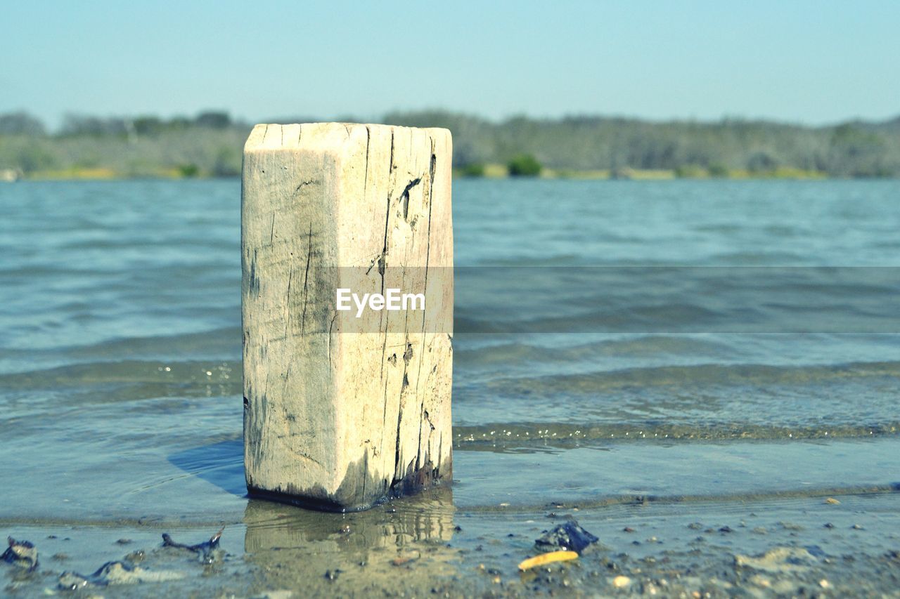 View of wooden post in water