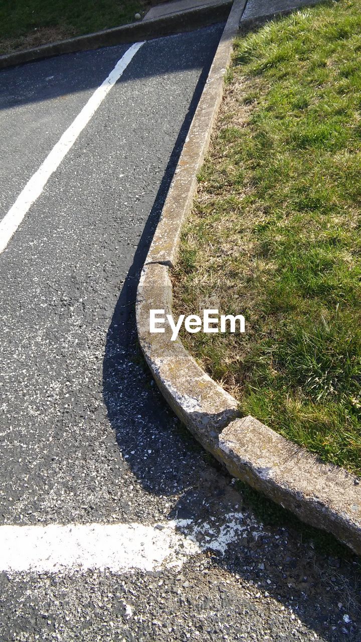 HIGH ANGLE VIEW OF FOOTPATH BY GRASS