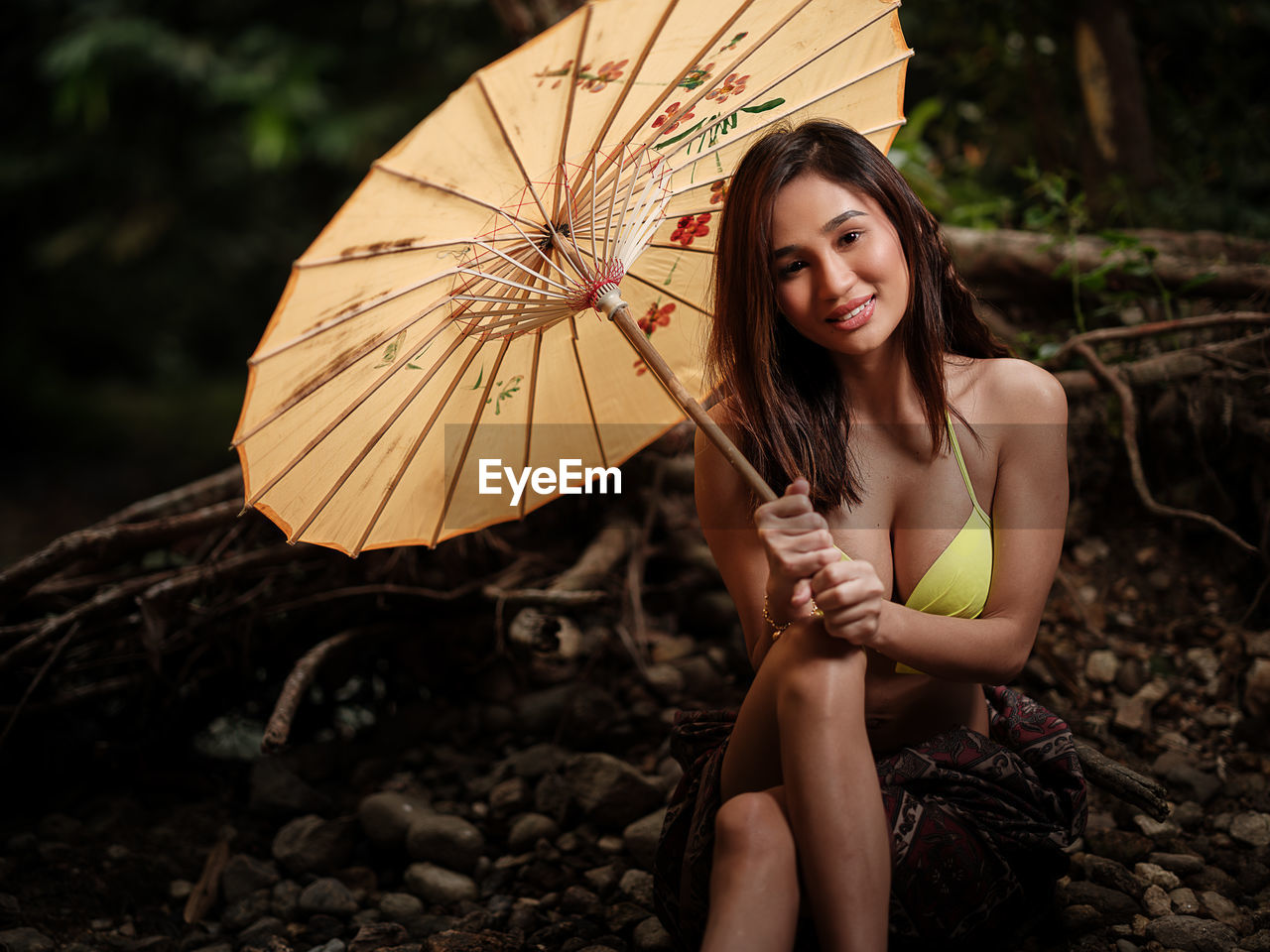 Portraiture shot of a beautiful asian female model in bikini at a river