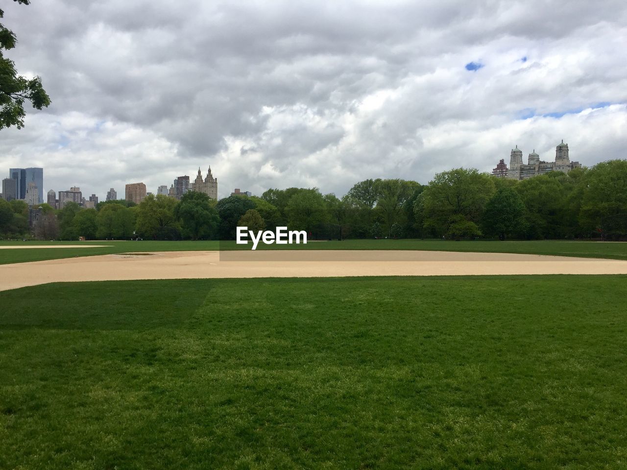 Golf course against cloudy sky