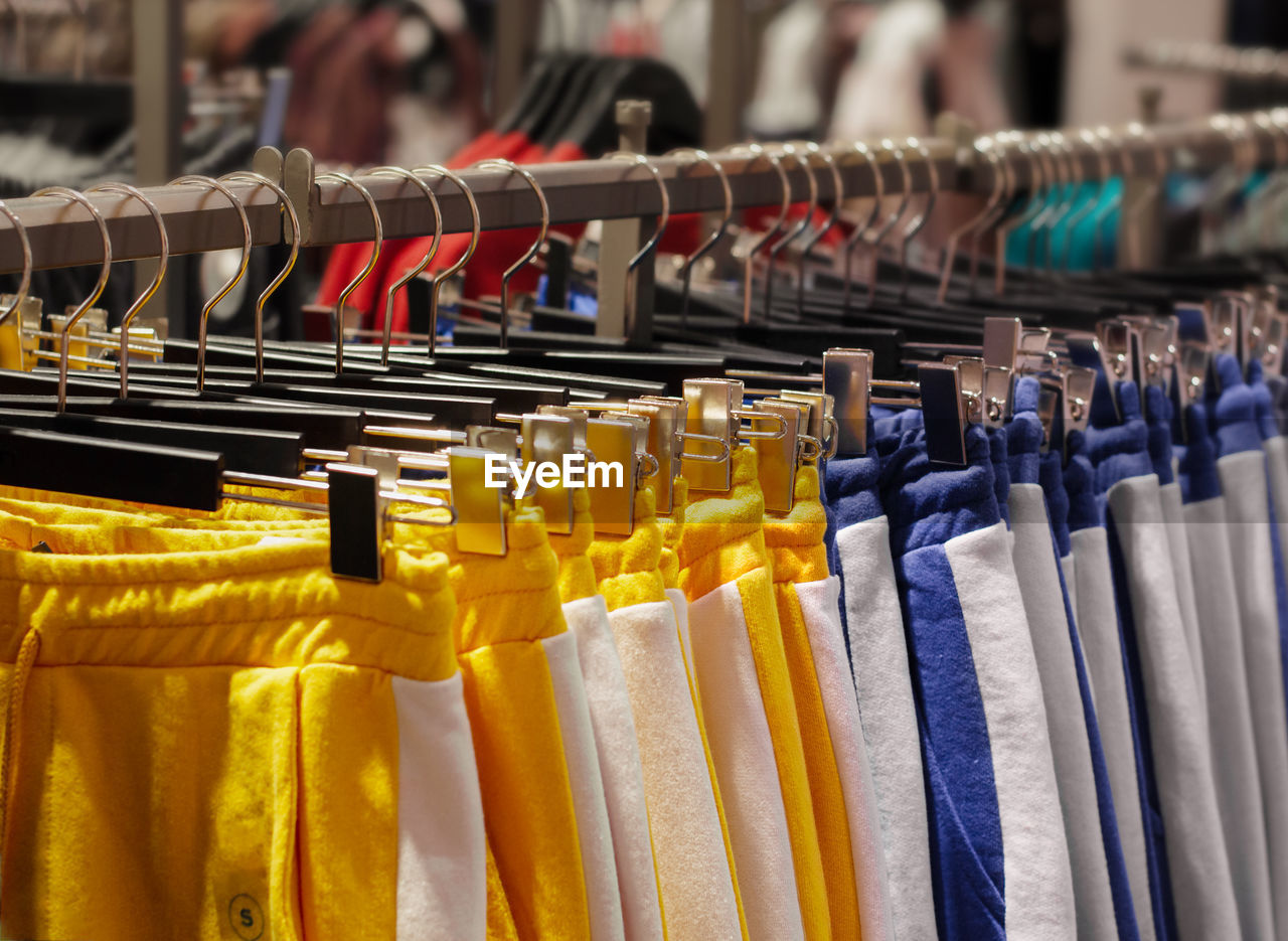 Bright clothes on hangers in the store. close-up and selective focus