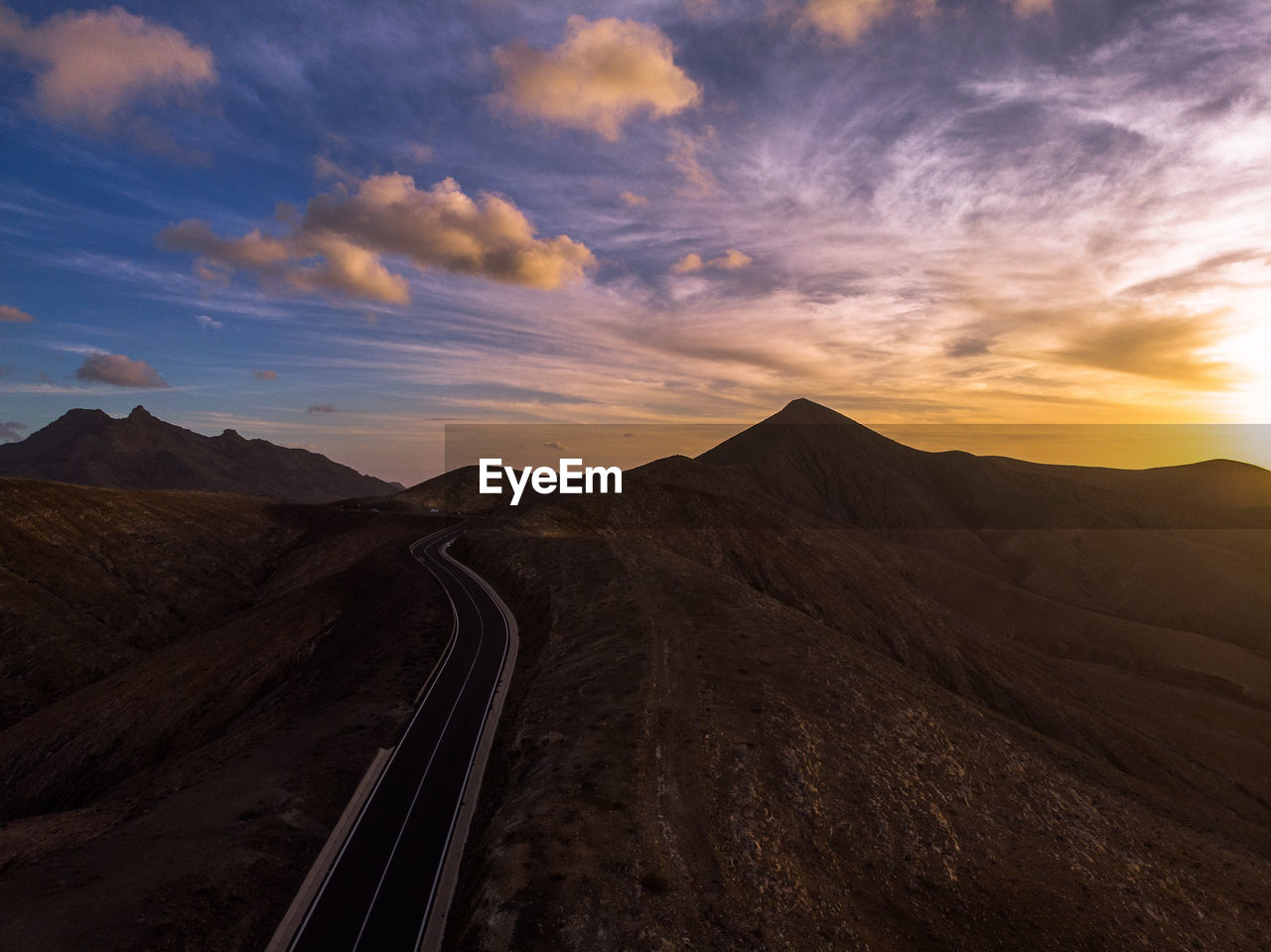 Scenic view of road against sky during sunset