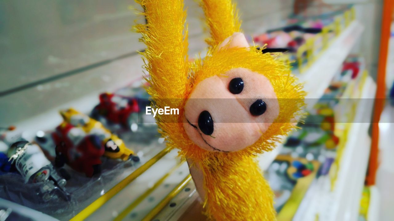 Close-up of yellow monkey toy for sale at store