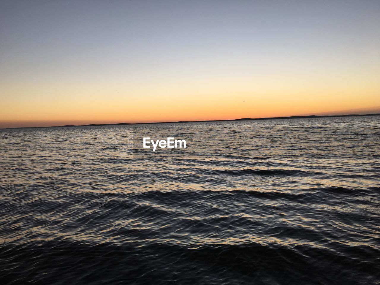 Scenic view of sea against clear sky during sunset