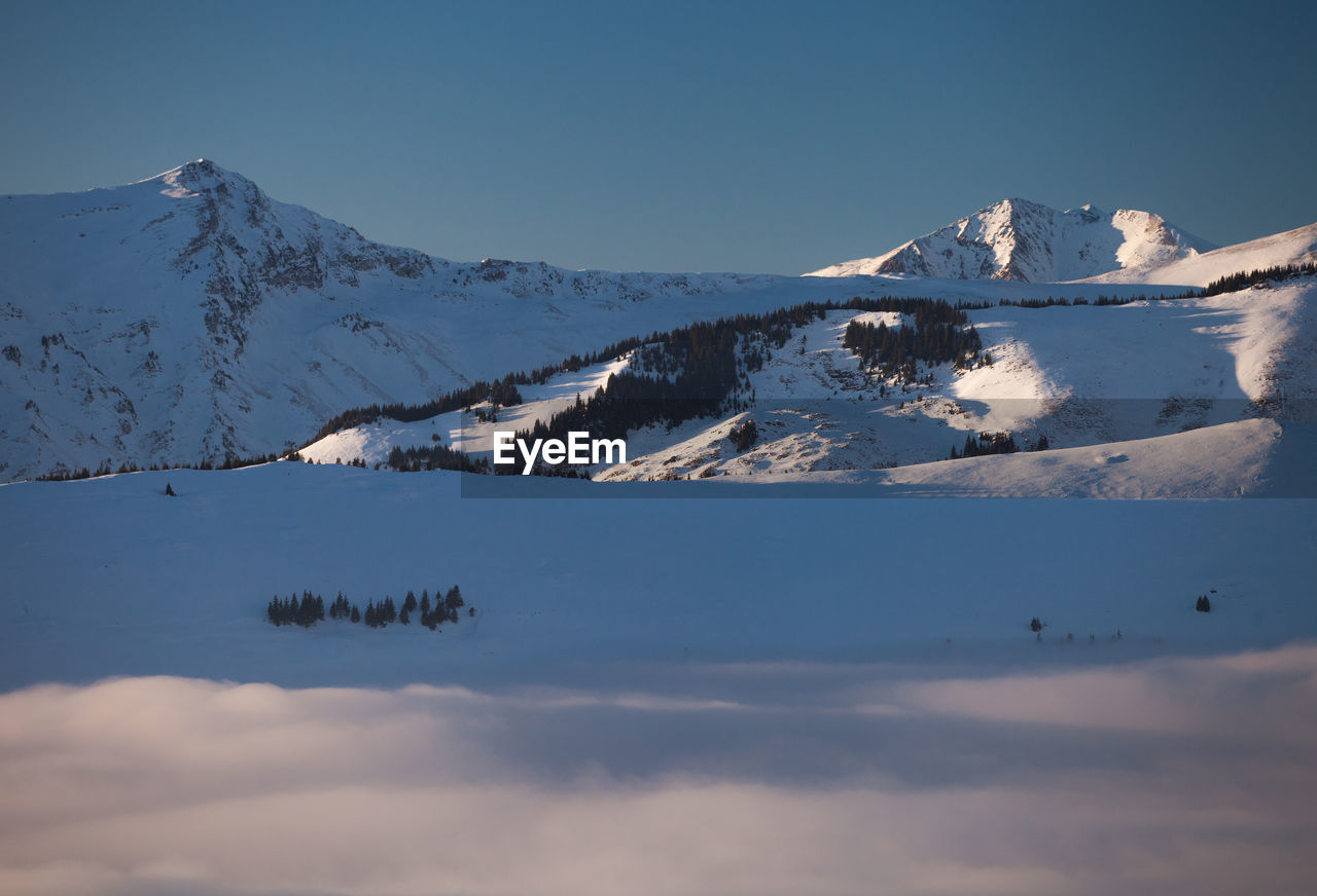 Scenic view of snowcapped mountains against sky