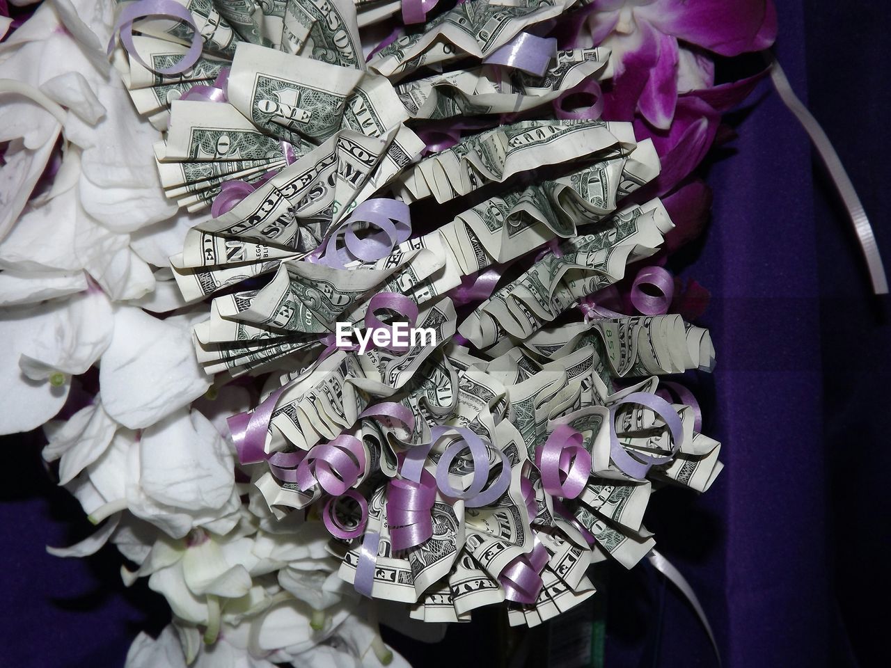 High angle view of decoration made up from american one dollar bills