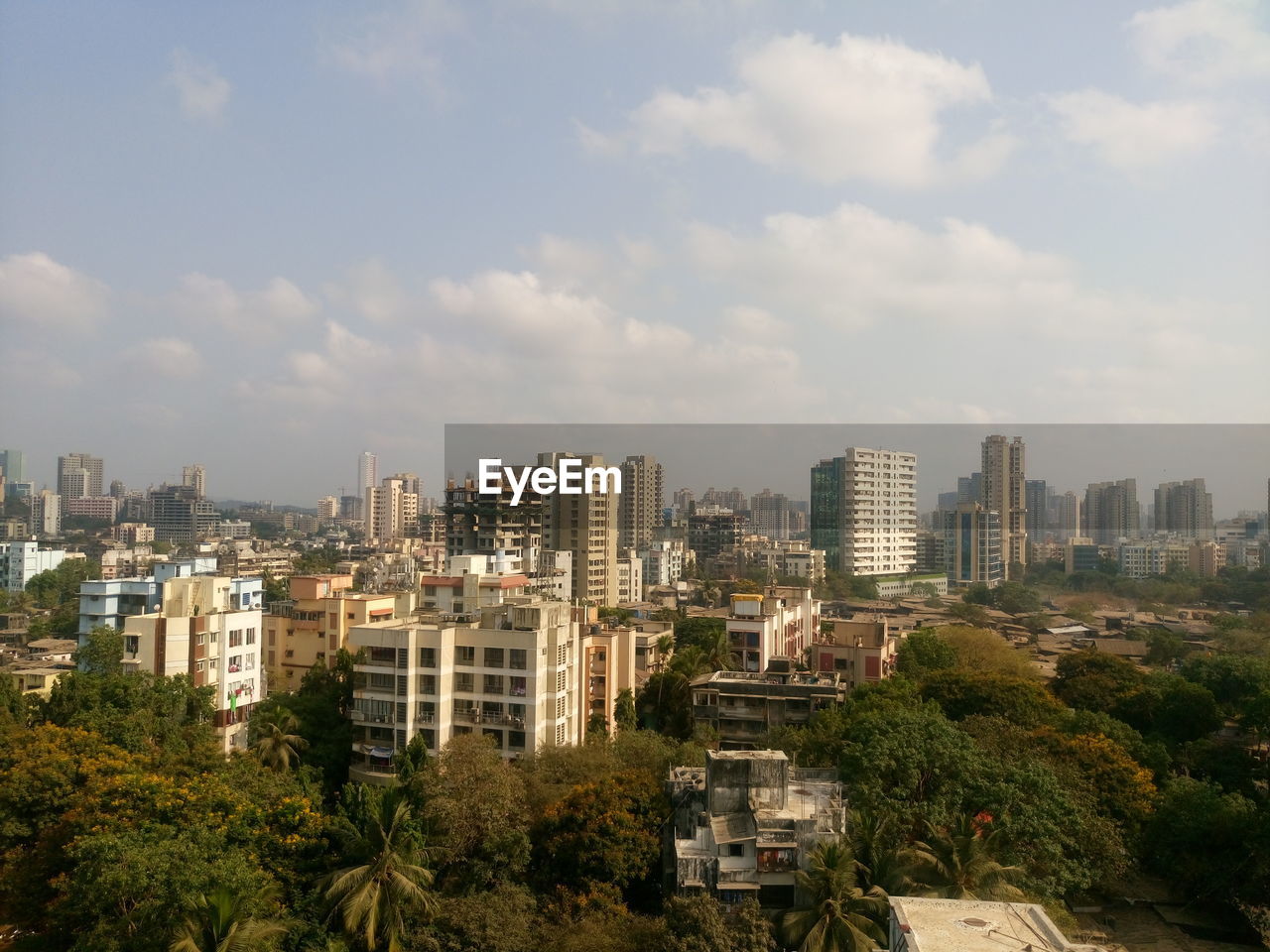 HIGH ANGLE VIEW OF BUILDINGS AGAINST SKY IN CITY