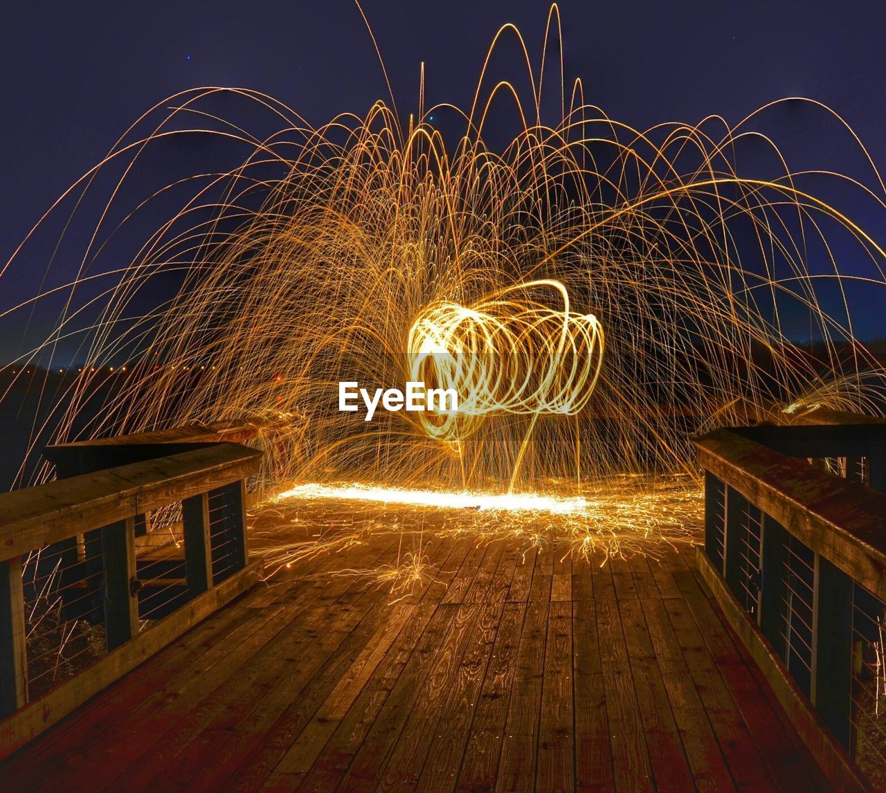 Sparks of light on wooden jetty