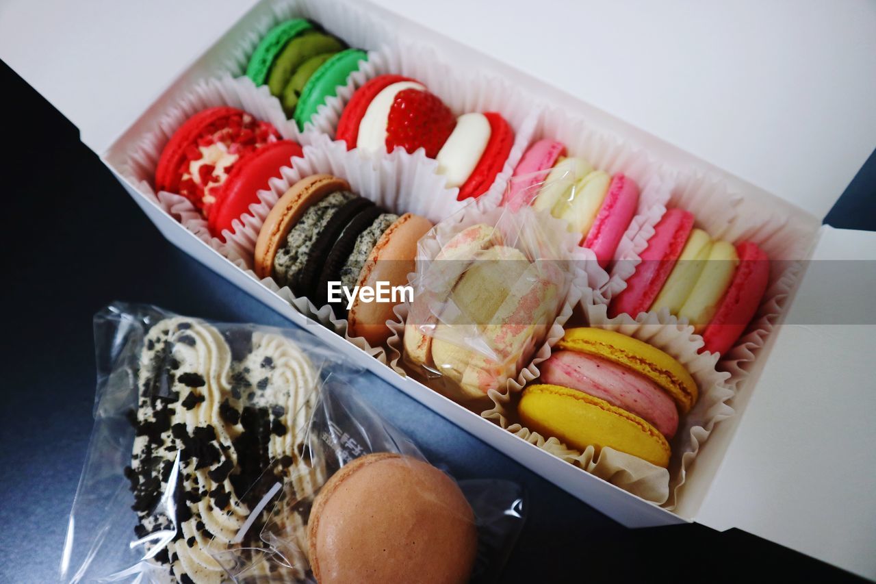 High angle view of macaroons in box on table