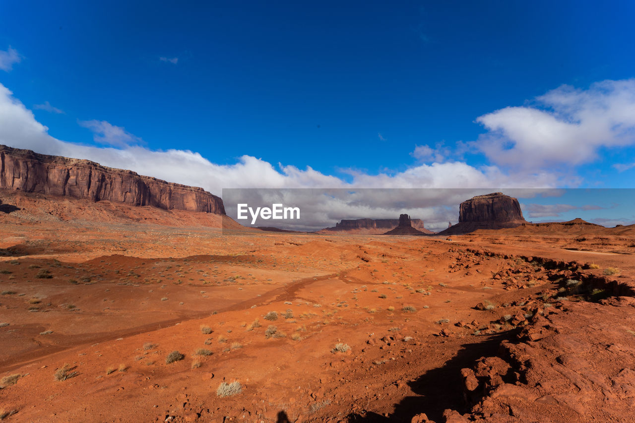 Scenic view of rocky mountains against blue sky