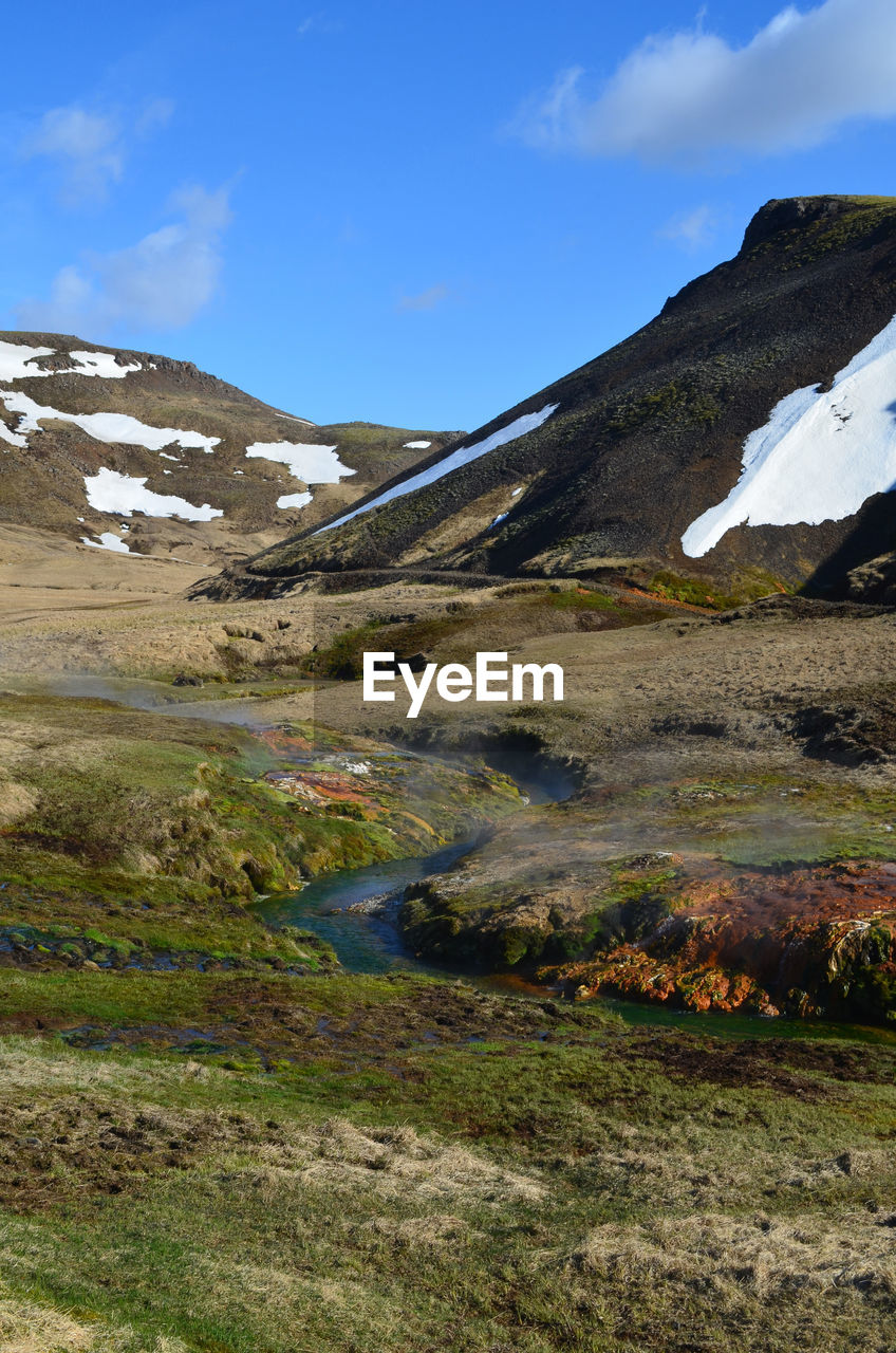 Flowing stream fed by a bubbling hot spring in rural iceland.