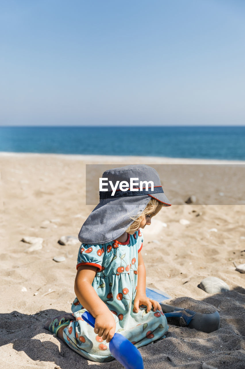 Cute girl sitting at beach