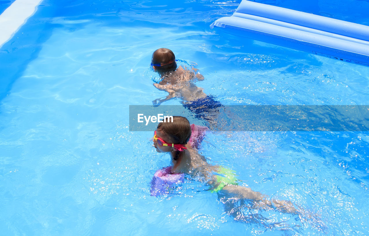 High angle view of kids swimming in pool