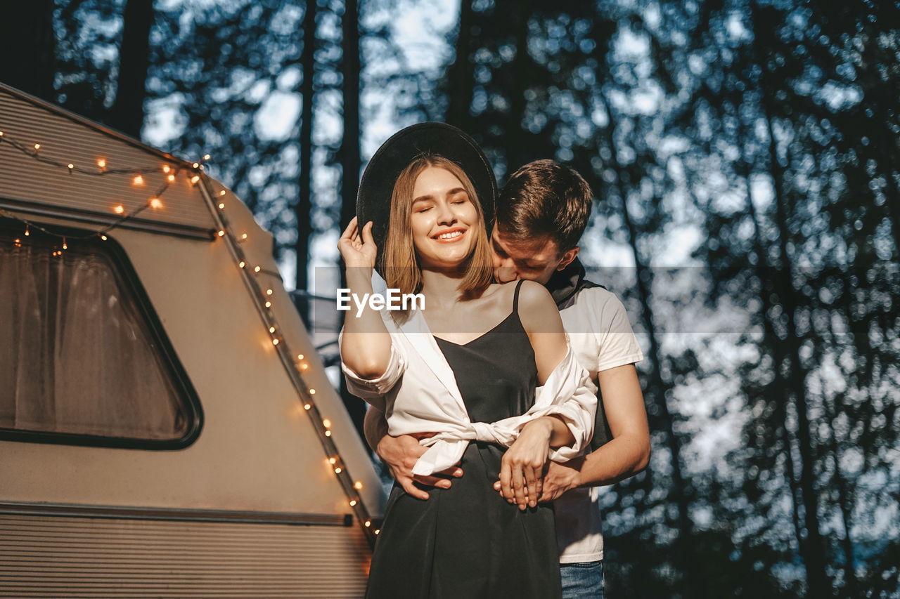 Close-up of couple embracing in forest