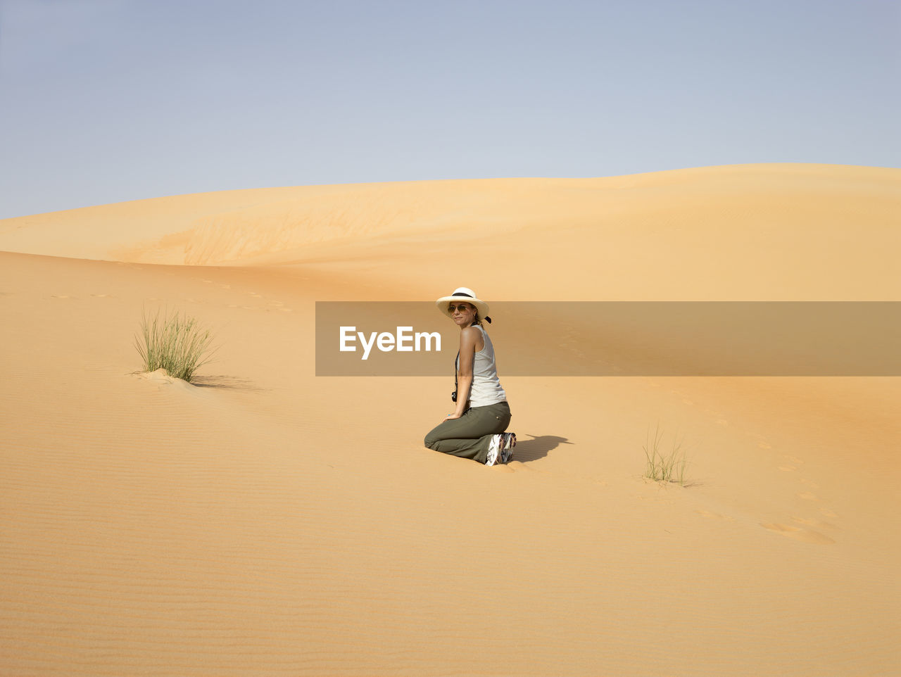 PERSON ON SAND DUNE AGAINST SKY