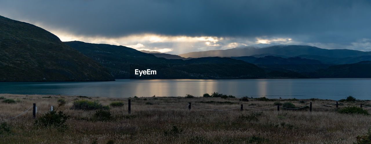 Scenic view of lake and mountains against sky