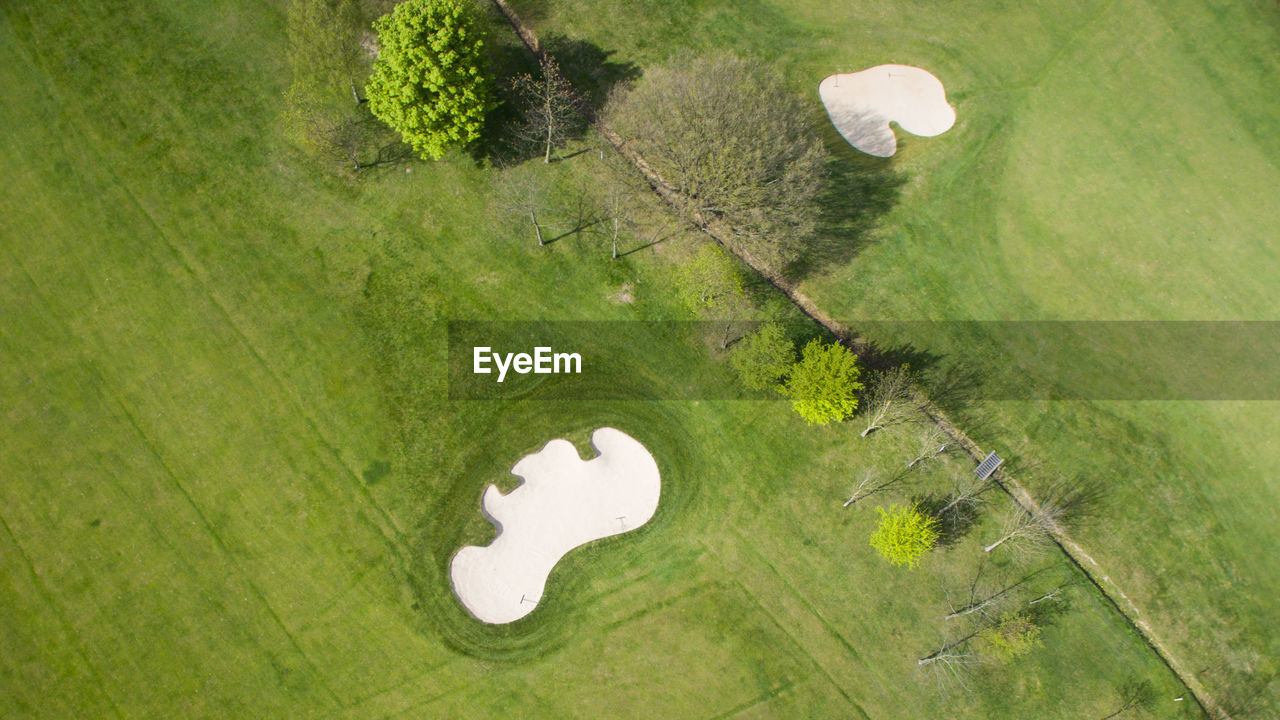 HIGH ANGLE VIEW OF GOLF COURSE ON GREEN LANDSCAPE