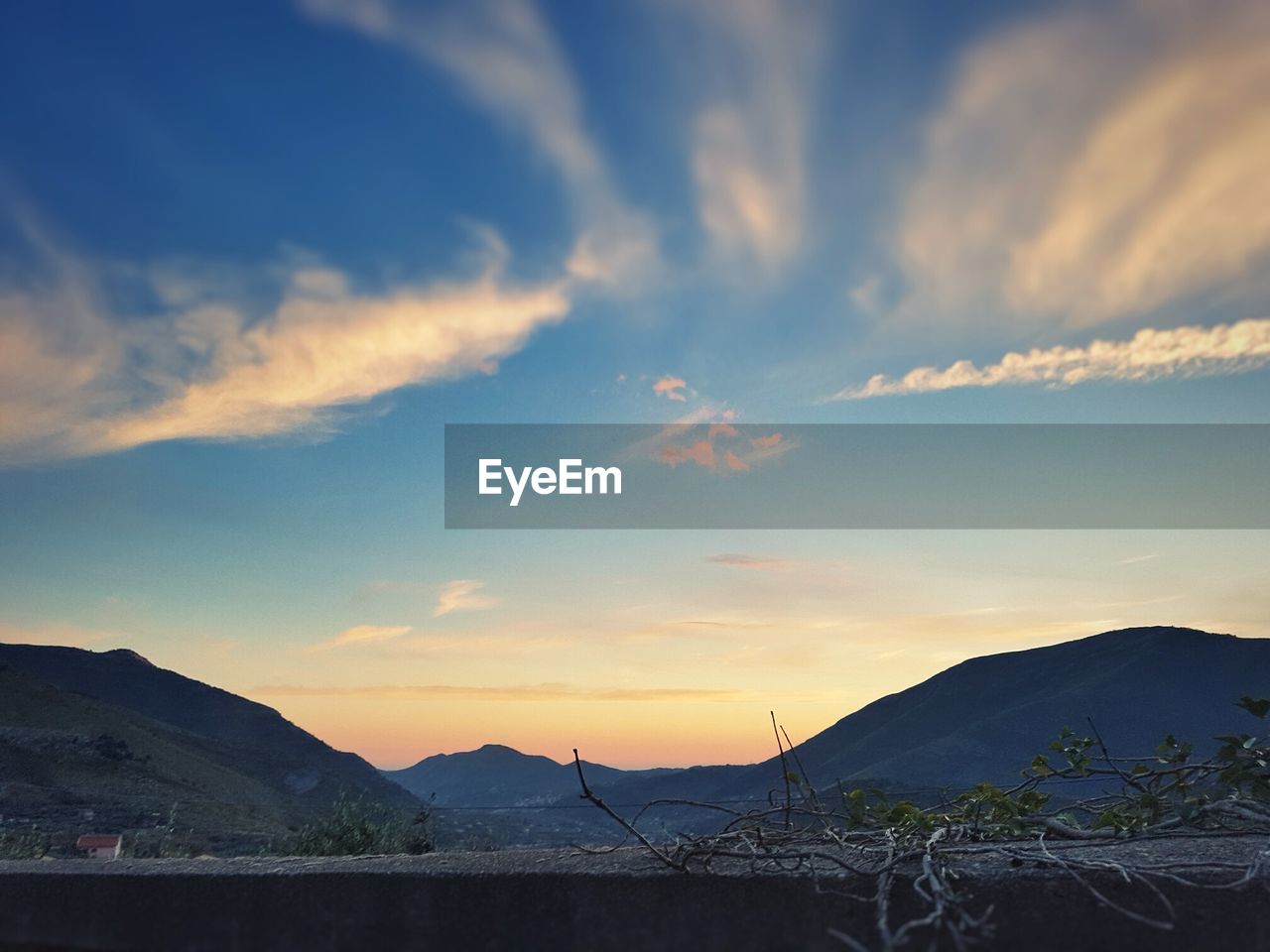 SILHOUETTE MOUNTAINS AGAINST SKY AT SUNSET