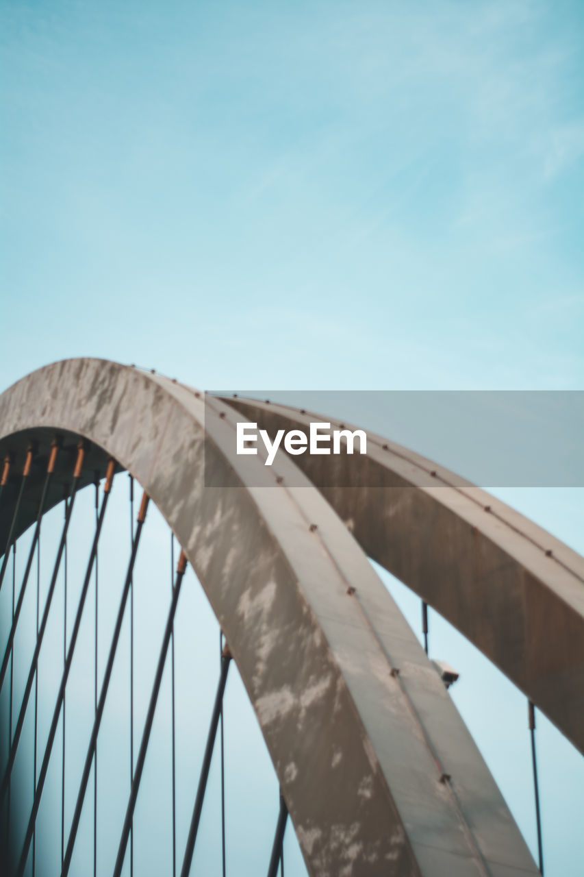 Low angle view of bridge against clear blue sky