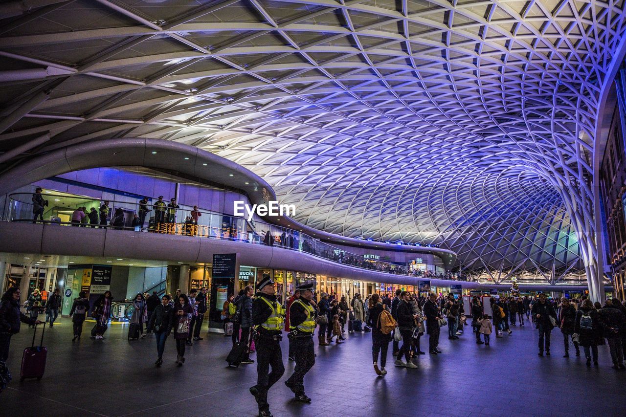 PEOPLE IN ILLUMINATED MODERN BUILDING