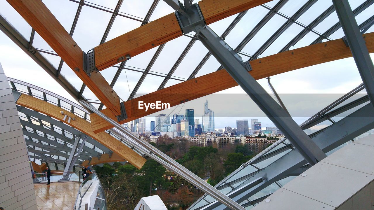 MODERN CITYSCAPE AGAINST SKY SEEN THROUGH BRIDGE