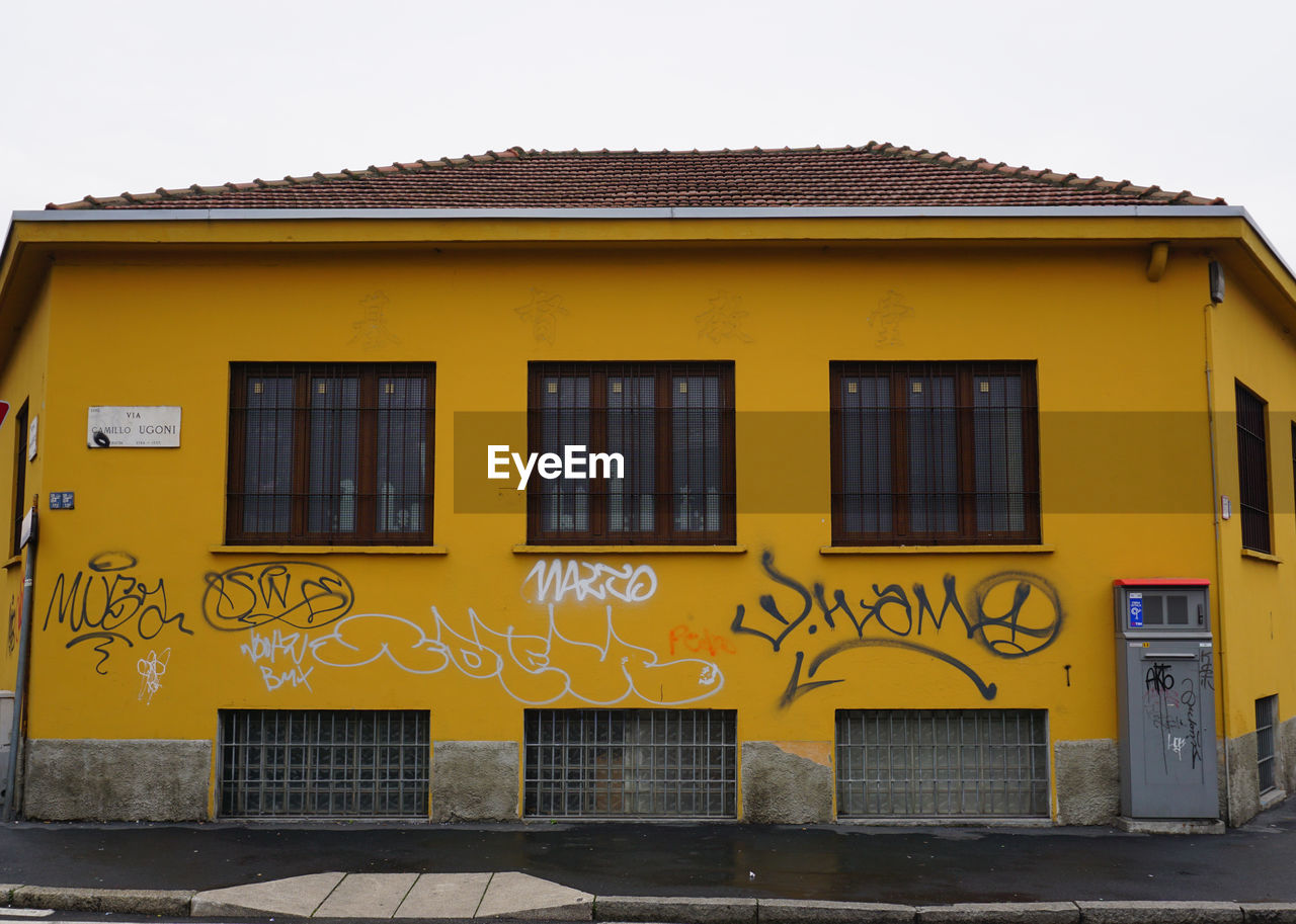 YELLOW BUILDING AGAINST SKY