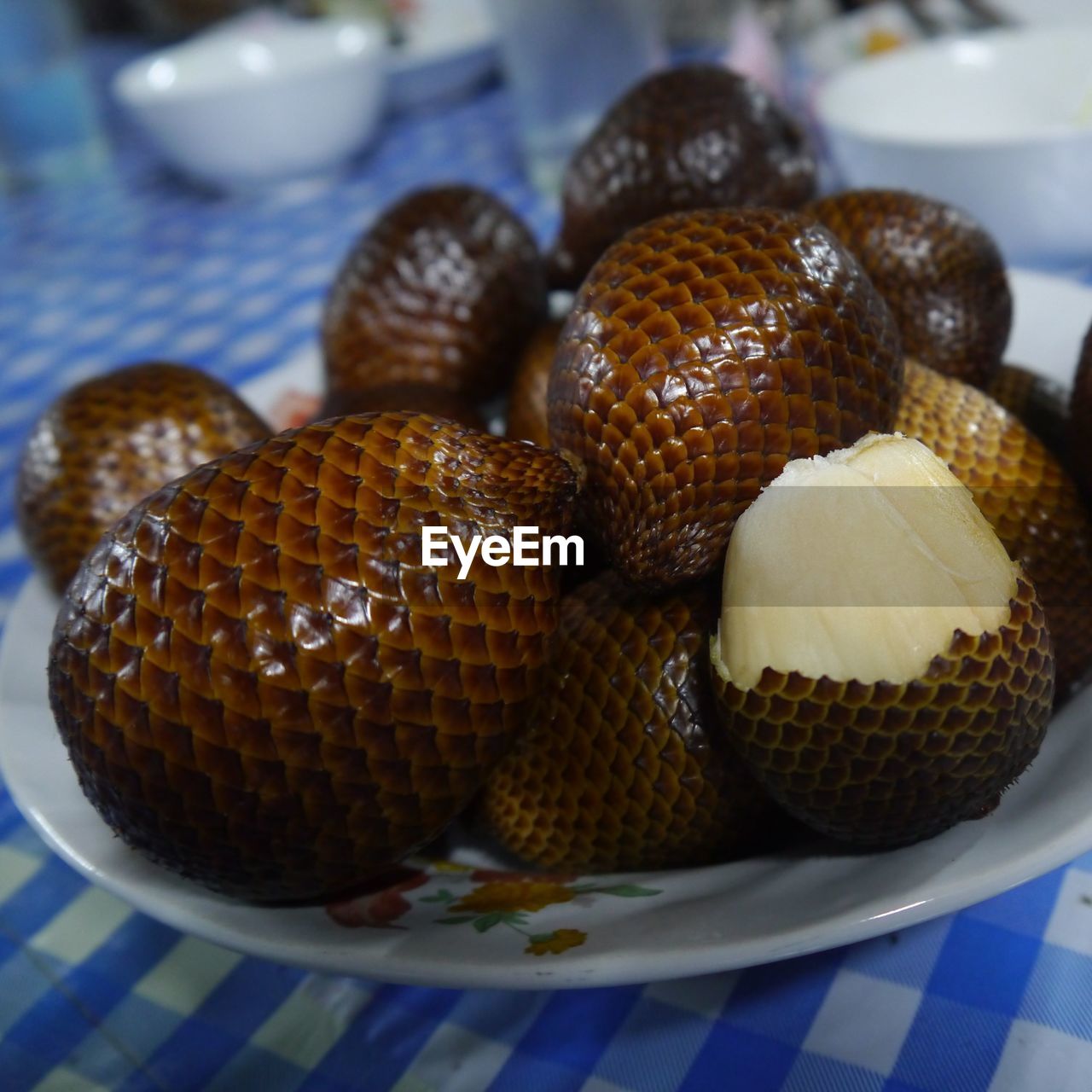 Close-up of snake fruits in plate on table