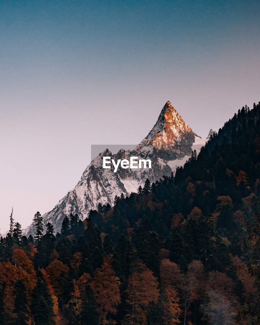 Scenic view of snowcapped mountains against clear sky