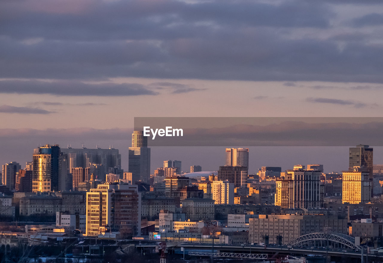 Buildings in city at sunset