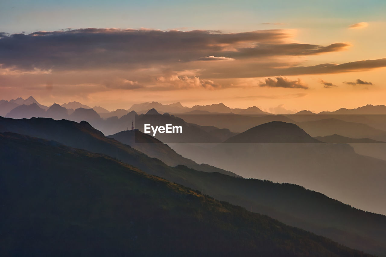 Scenic view of silhouette mountains against sky during sunset