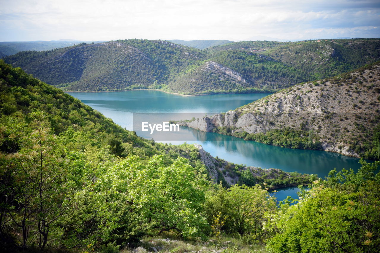 Scenic view of lake and mountains against sky