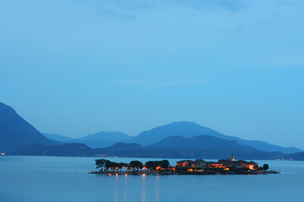 Scenic view of lake maggiore against sky at dusk