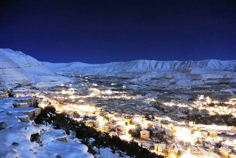SNOW COVERED MOUNTAINS AT NIGHT