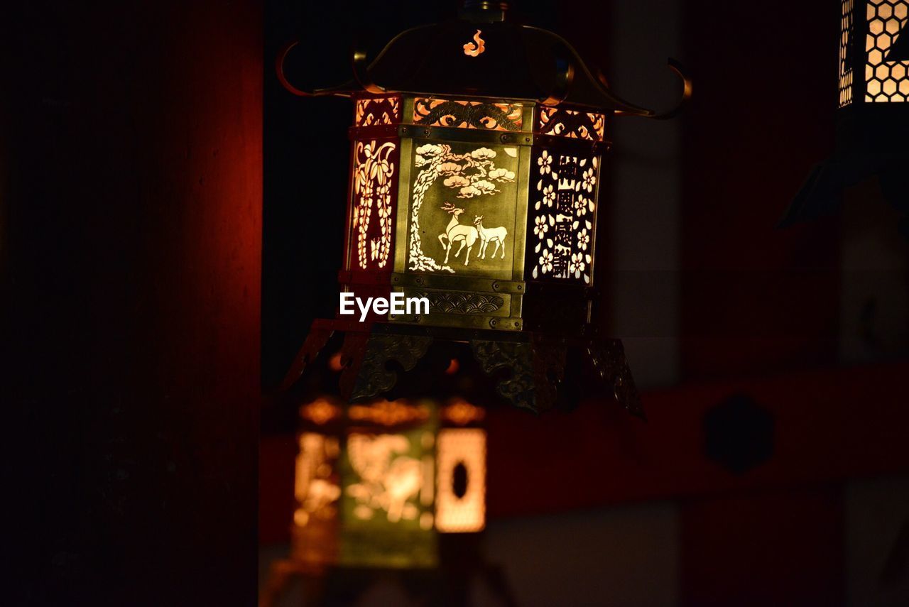 CLOSE-UP OF ILLUMINATED LANTERN