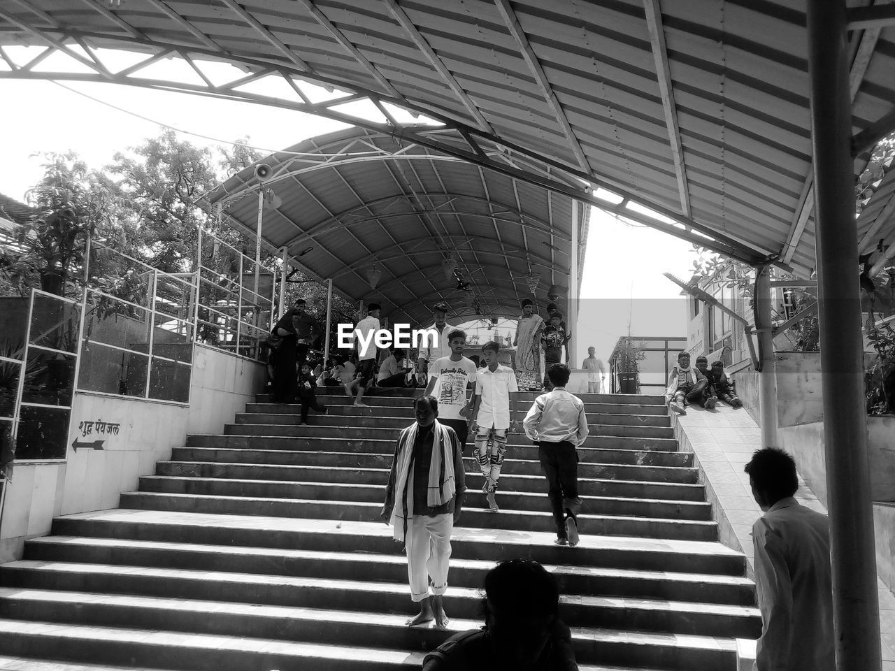 PEOPLE WALKING ON STAIRCASE IN CITY