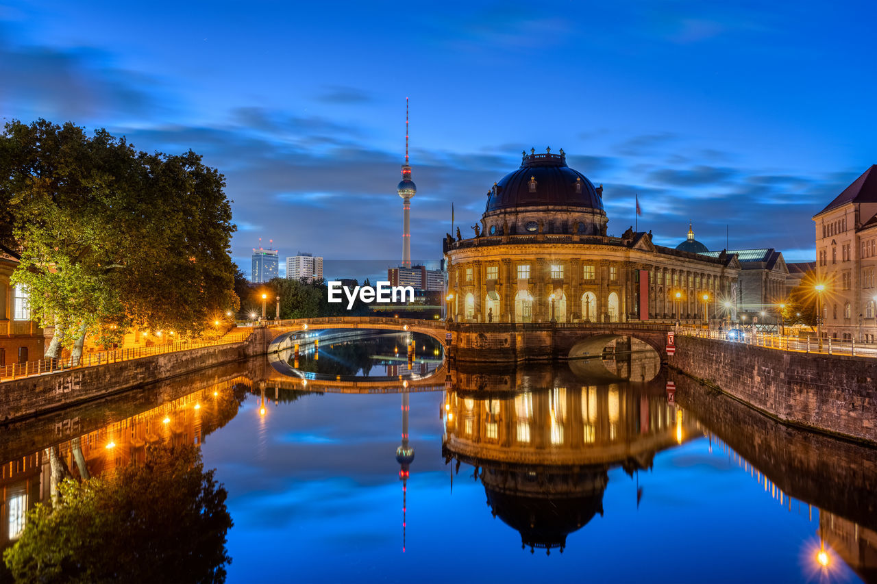 The bode-museum and the television tower reflected in the river spree in berlin at night