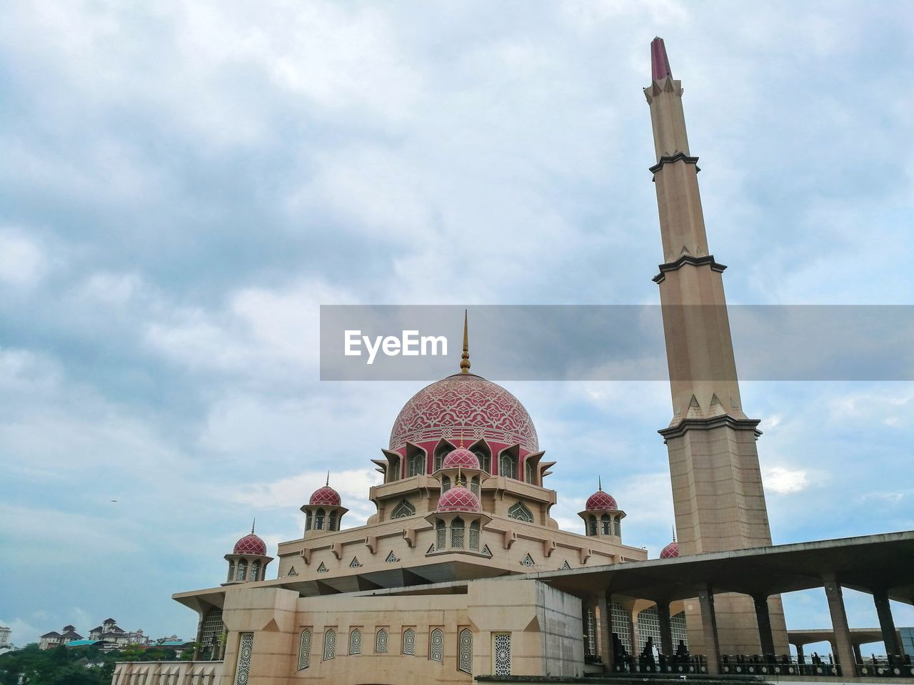 Landscape view of putra mosque against cloudy sky