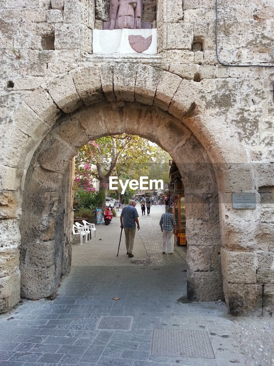 VIEW OF TOURISTS WALKING THROUGH ARCH