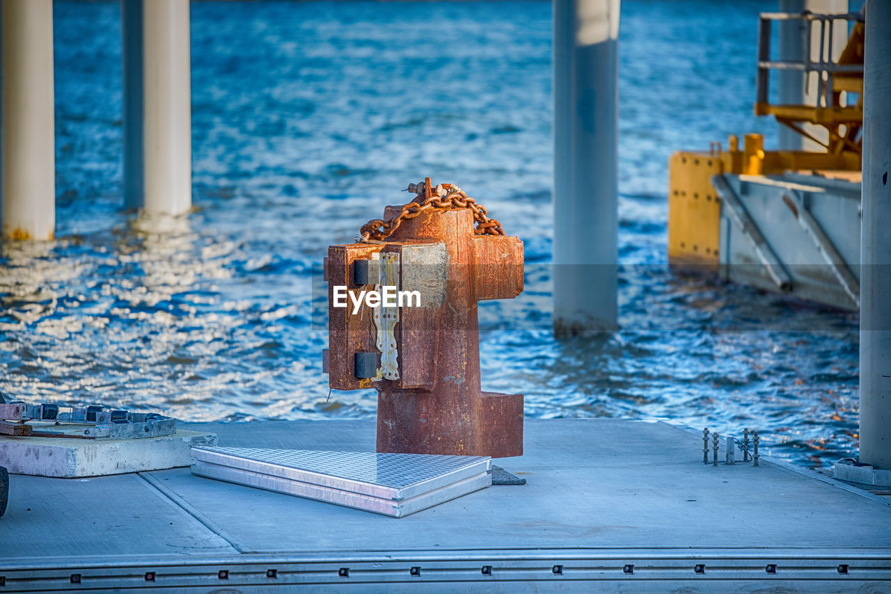 Close-up of wooden post on pier over sea