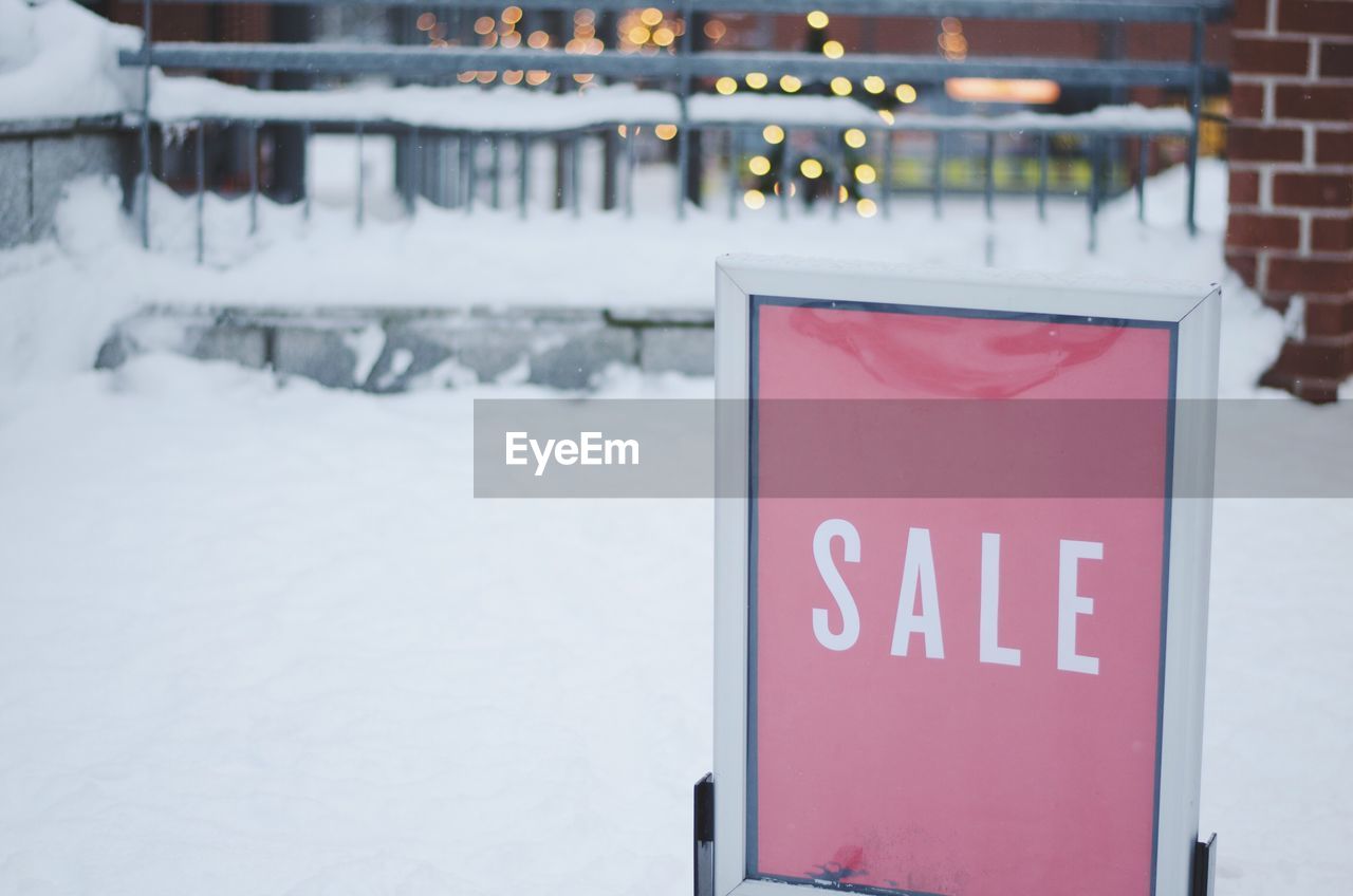 CLOSE-UP OF TEXT ON SNOW COVERED WITH ICE