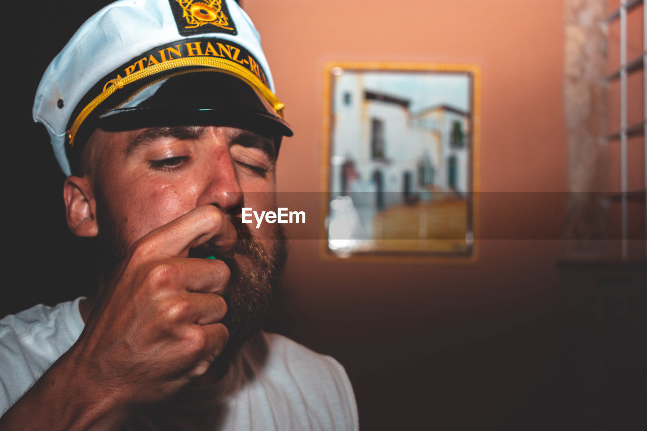 Portrait of a man wearing captains hat