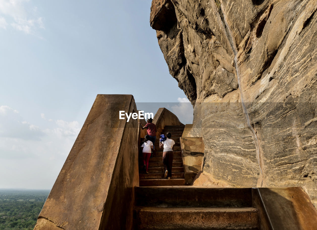 PEOPLE WALKING ON ROCK