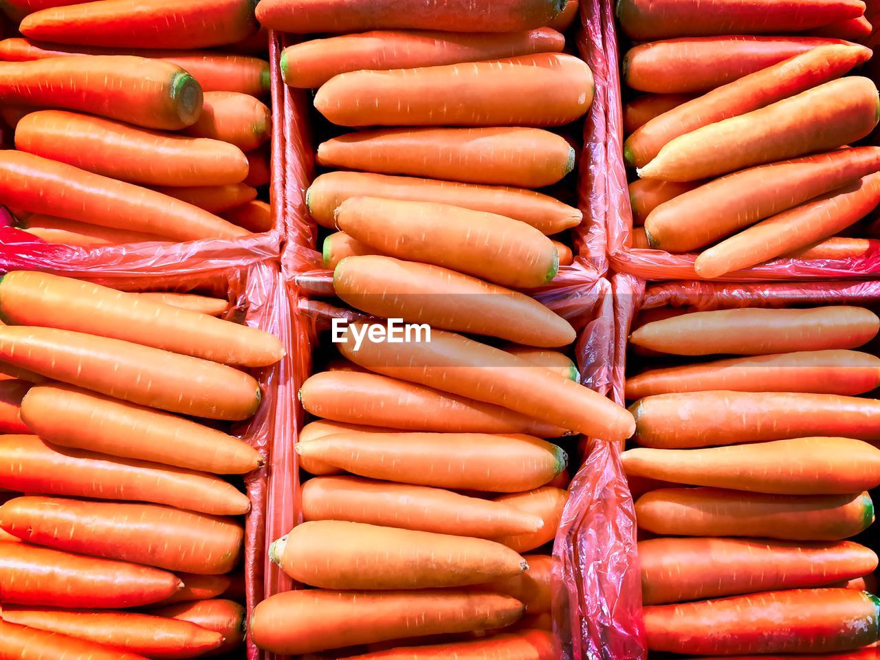 Orange background of fresh carrots