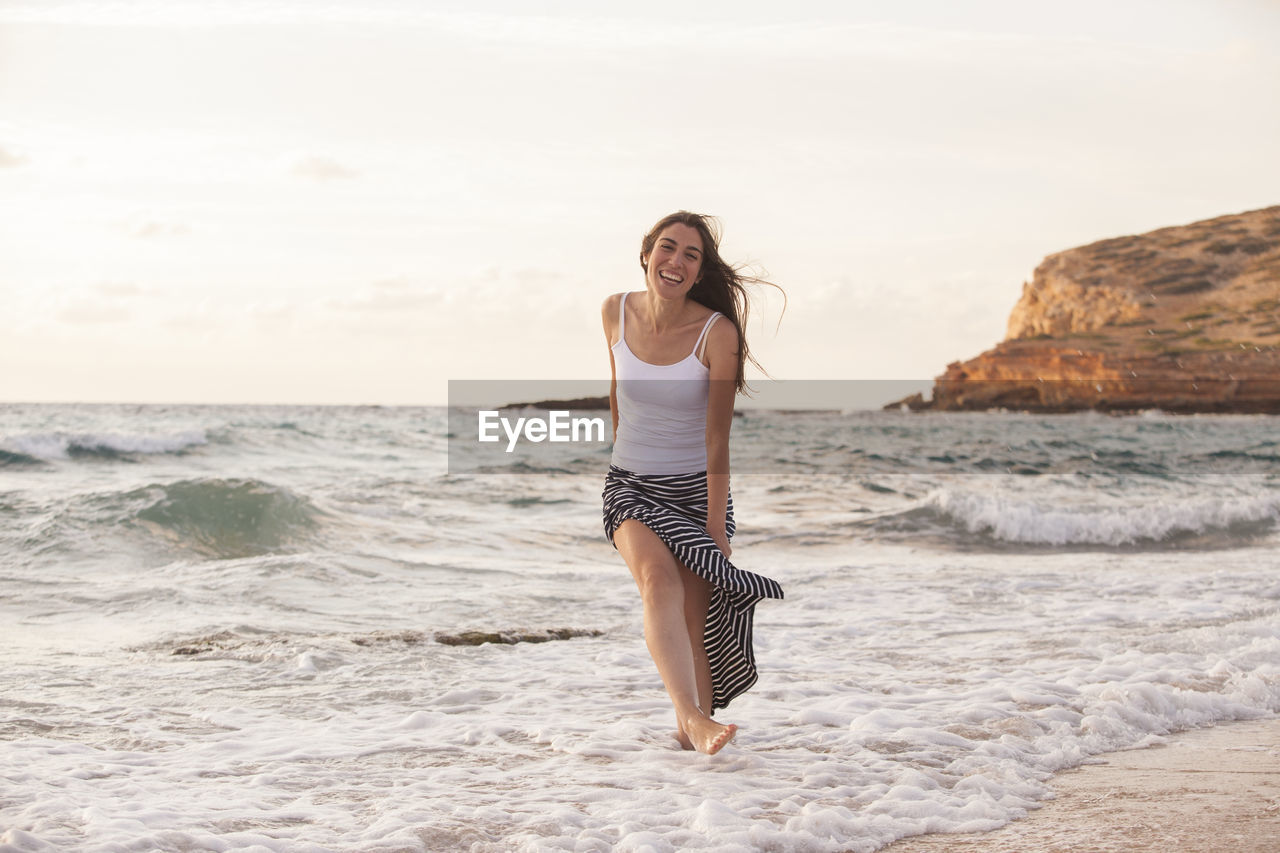 YOUNG WOMAN ON BEACH