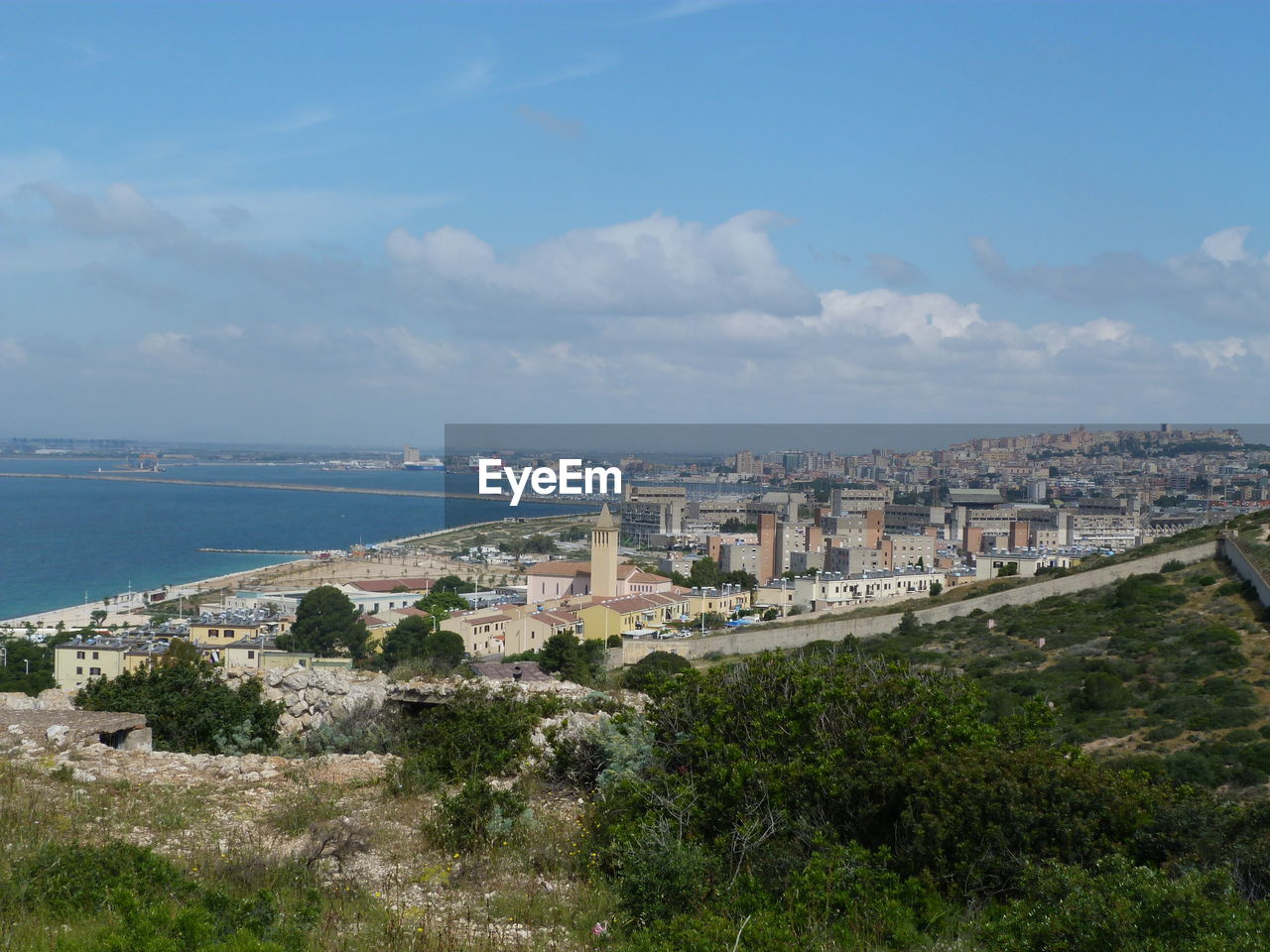 Scenic view of sea and buildings against sky